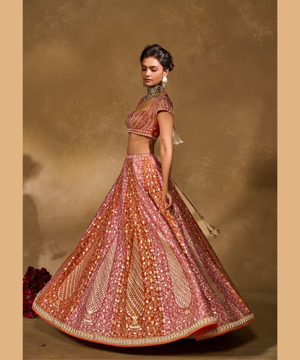 SABA LEHENGA - Mauve Pink and Orange lehenga intricately embroidered with pita, glass beads, stones, pearls, zardozi, and zari paired with a delicately embellished sweetheart neck cap sleeve blouse -  Leher by Chamee and Palak
