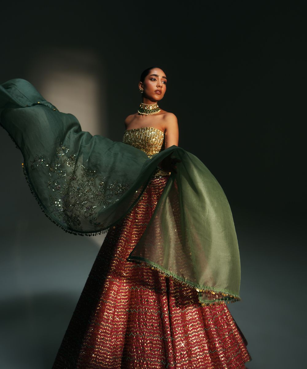 GARIMA - HAND EMBROIDERED RANI PINK LEHENGA WITH GOLDEN CORSET -  Mehfil by Mahima Mahajan