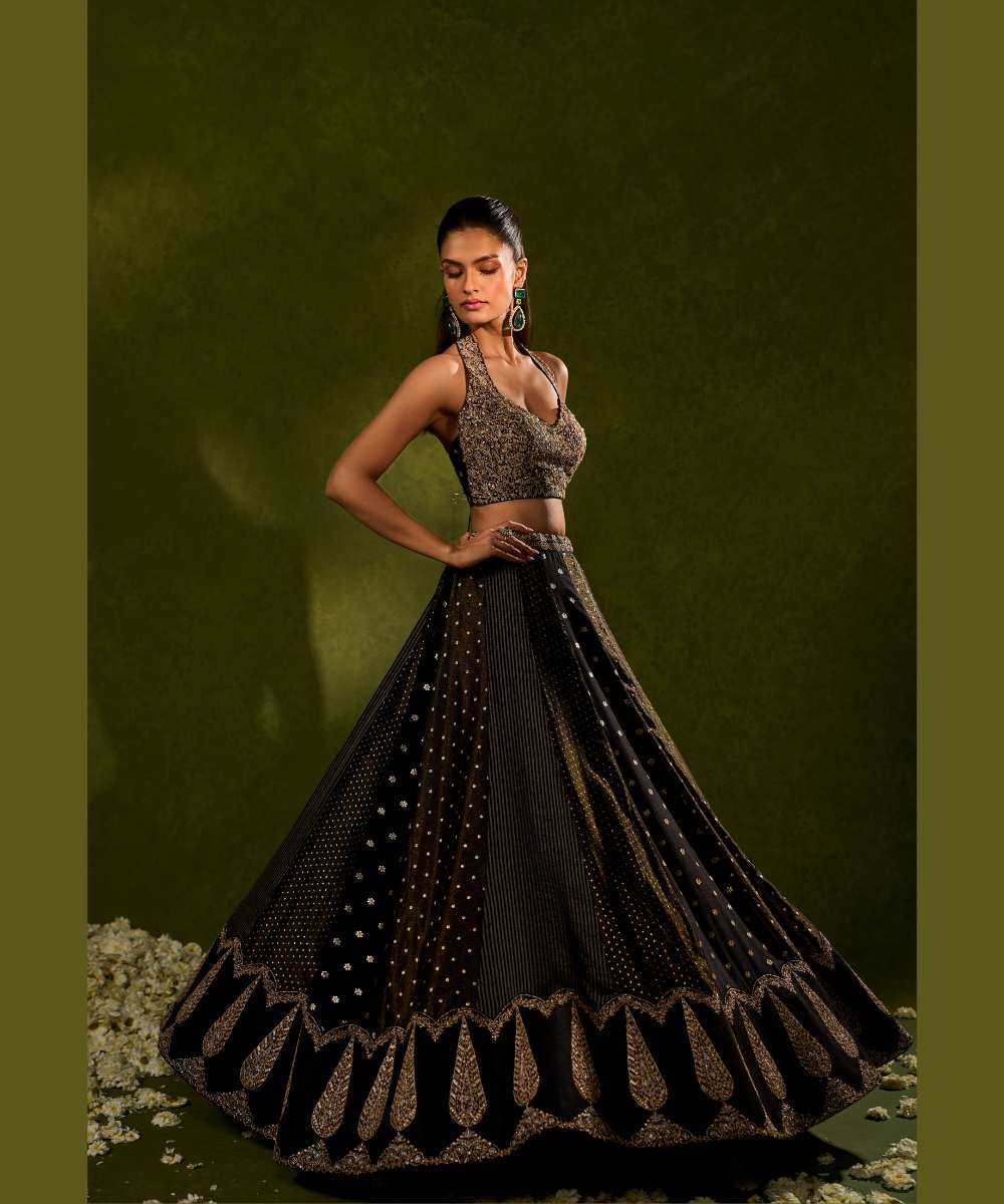 NANDANA LEHENGA - Black tissue woven jamewar lehenga delicately embroidered with a zari hem paired with a richly embroidered halter-neck blouse - Leher by Chamee and Palak