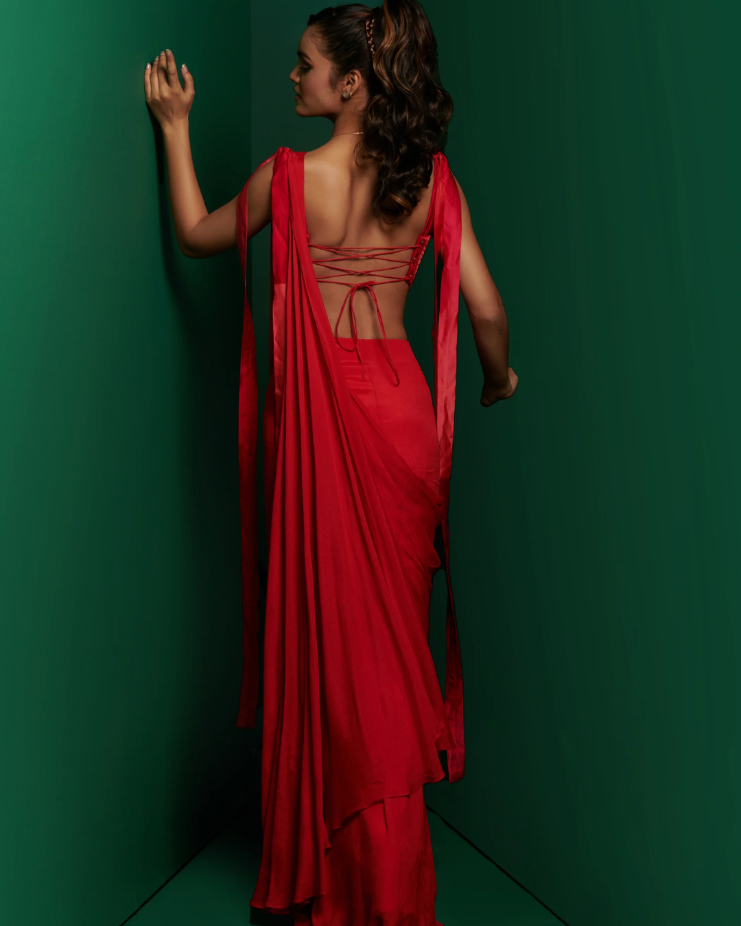 K&A by Karishma and Ashita - Crimson red cut out corset with pleated drape saree From Barre Oblique