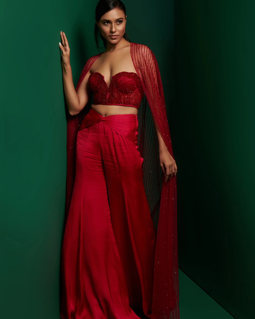 K&A by Karishma and Ashita - Red embellished corset top with front knot pants and embellished cape From Barre Oblique