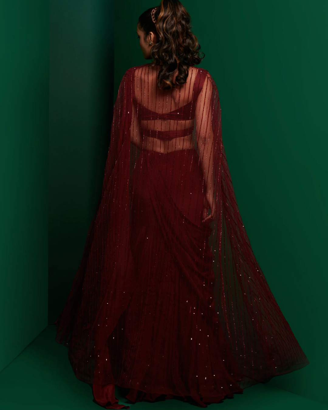 K&A by Karishma and Ashita - Dark maroon cross body blouse with drape saree and embellished cape From Barre Oblique