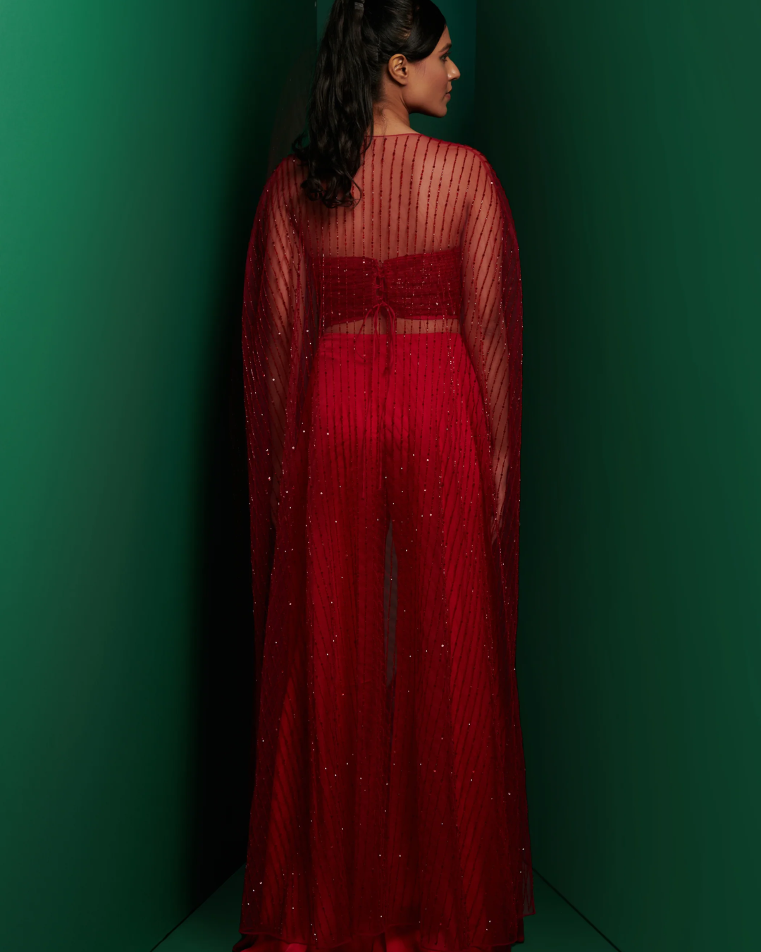 K&A by Karishma and Ashita - Red embellished corset top with front knot pants and embellished cape From Barre Oblique