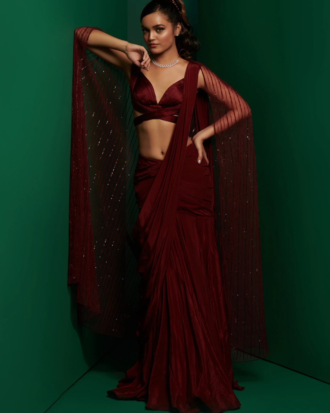 K&A by Karishma and Ashita - Dark maroon cross body blouse with drape saree and embellished cape From Barre Oblique