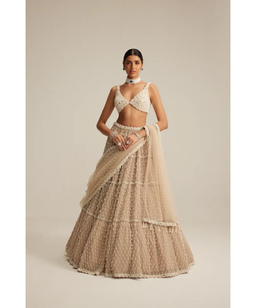 VVANI VATS- Light Beige Pearl Drop Multi Tier Lehenga Set.