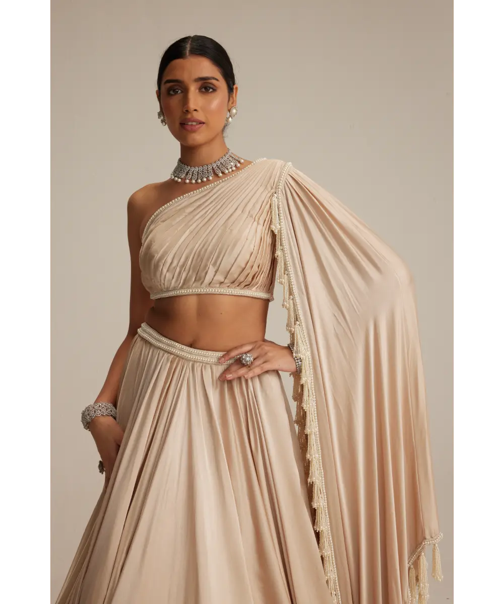 VVANI VATS- Light Beige Dense mirror and pearl one shoulder lehenga set