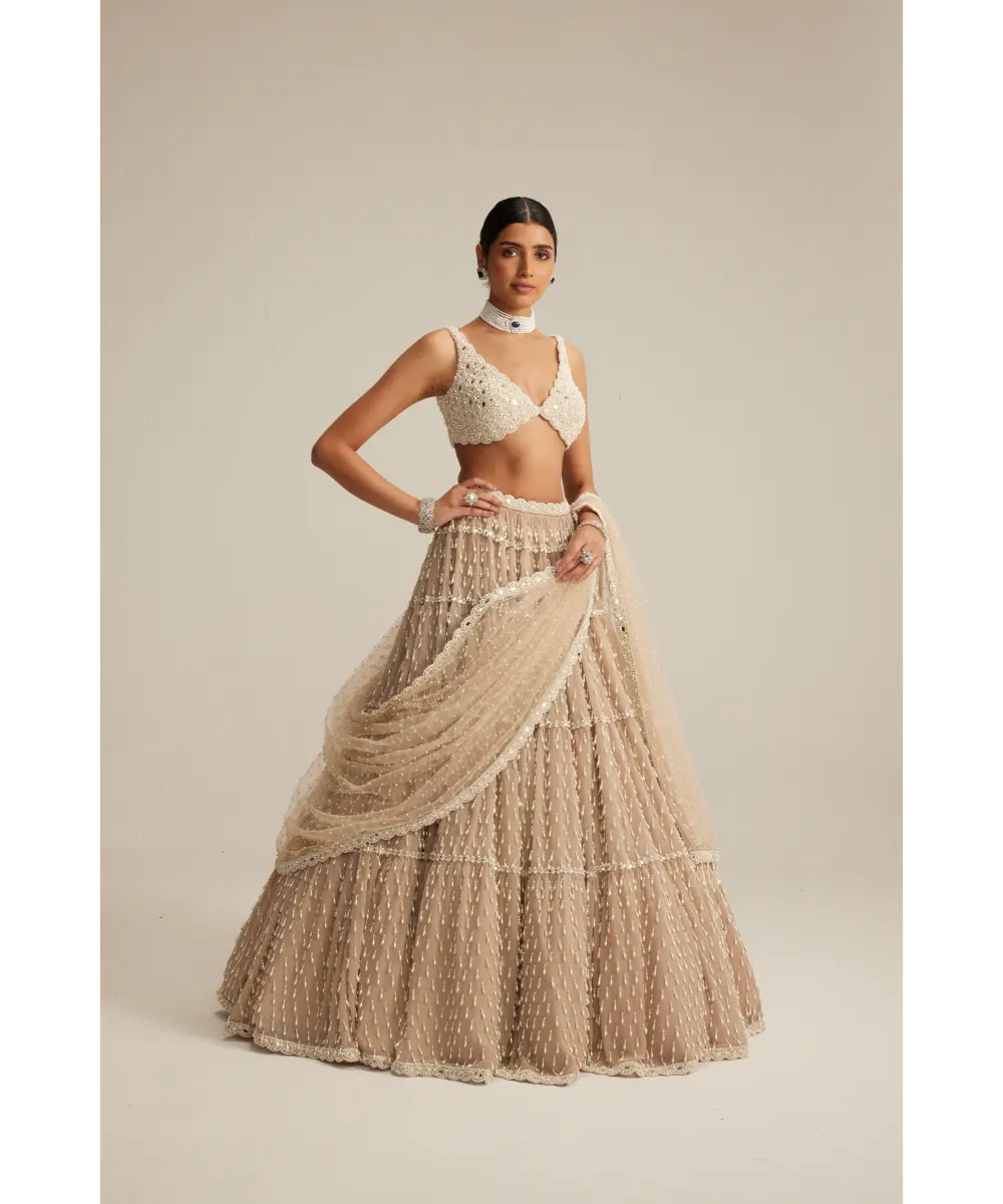 VVANI VATS- Light Beige Pearl Drop Multi Tier Lehenga Set.